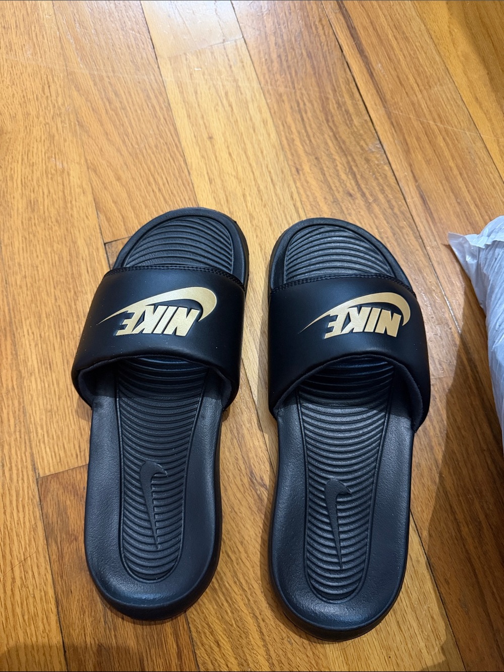 Nike Black Slides with Gold Logo